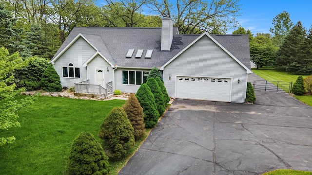 7512 Trophy Ct, Grass Lake, MI 49240 - view of front of house with asphalt driveway, a garage, a wooden deck, a chimney, and a gate