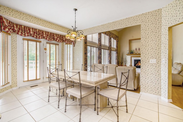 9968 Tuscany Valley Way S, Lyon, MI 48178 - dining space featuring wallpapered walls, a chandelier, light tile patterned floors, baseboards, and plenty of natural light