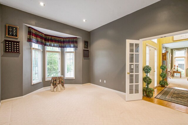 9968 Tuscany Valley Way S, Lyon, MI 48178 - carpeted empty room with baseboards, french doors, recessed lighting, and wood finished floors