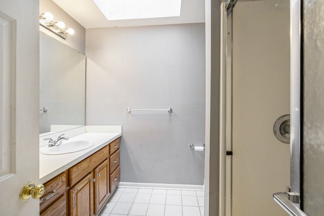 9968 Tuscany Valley Way S, Lyon, MI 48178 - bathroom with a skylight, tile patterned flooring, vanity, and baseboards