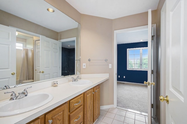 9968 Tuscany Valley Way S, Lyon, MI 48178 - bathroom featuring tile patterned flooring, baseboards, and double vanity