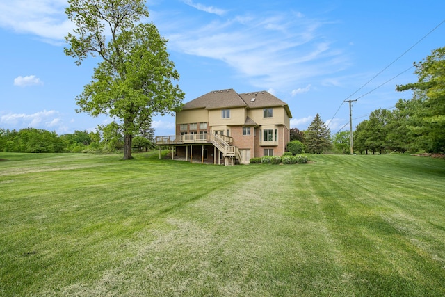 9968 Tuscany Valley Way S, Lyon, MI 48178 - rear view of property featuring a wooden deck, stairway, a yard, and brick siding