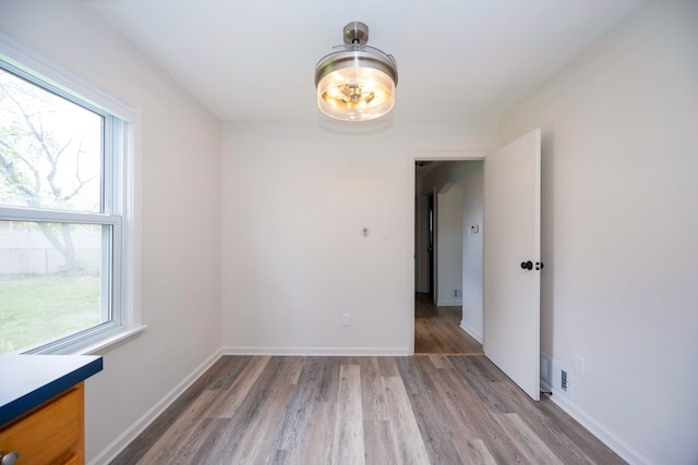 5875 S Madison St, Taylor, MI 48180 - unfurnished room featuring healthy amount of natural light, light wood-style floors, and baseboards