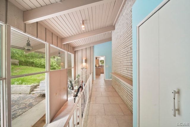 3224 Thornhill Dr, Adrian, MI 49221 - hall featuring beam ceiling, light tile patterned flooring, and brick wall