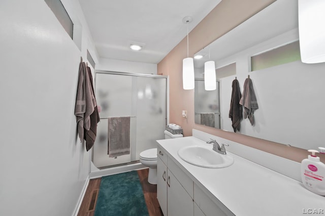 3224 Thornhill Dr, Adrian, MI 49221 - bathroom with wood finished floors, a shower stall, toilet, and vanity