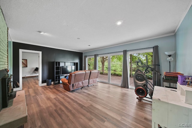 3224 Thornhill Dr, Adrian, MI 49221 - living area featuring ornamental molding, wood finished floors, a wood stove, a textured ceiling, and baseboards