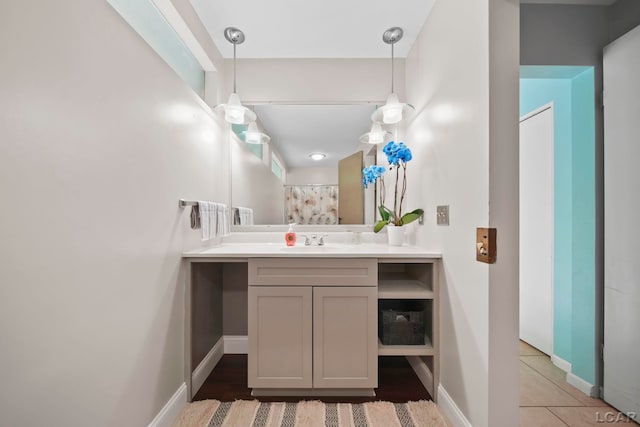 3224 Thornhill Dr, Adrian, MI 49221 - full bath with vanity, baseboards, and a shower with shower curtain