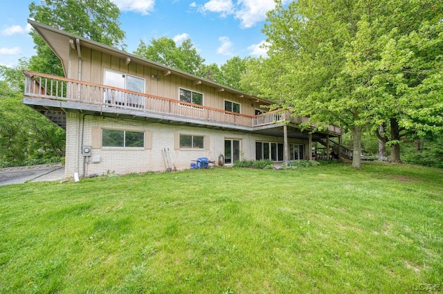 3224 Thornhill Dr, Adrian, MI 49221 - rear view of property featuring board and batten siding, a yard, brick siding, and a wooden deck