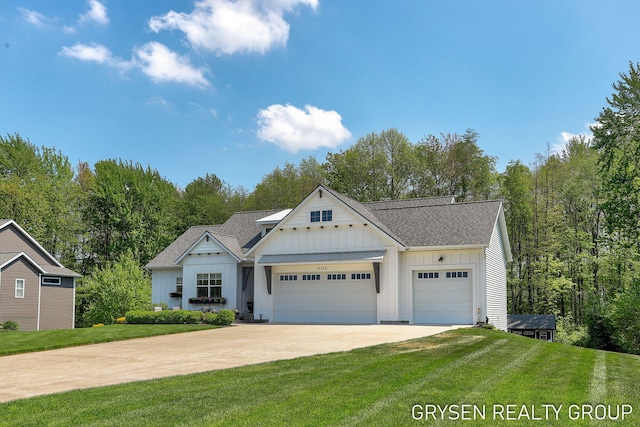 6326 Eaglewood Dr, Hudsonville, MI 49426 - view of front of house featuring board and batten siding, driveway, an attached garage, and a front lawn