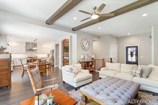 6326 Eaglewood Dr, Hudsonville, MI 49426 - living area featuring recessed lighting, beamed ceiling, a ceiling fan, dark wood-style floors, and arched walkways