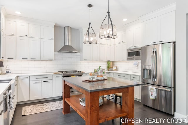 6326 Eaglewood Dr, Hudsonville, MI 49426 - kitchen with appliances with stainless steel finishes, wall chimney range hood, dark wood-style flooring, a chandelier, and recessed lighting