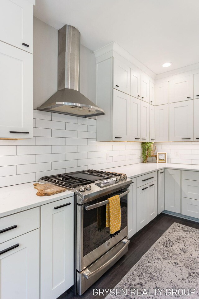6326 Eaglewood Dr, Hudsonville, MI 49426 - kitchen with wall chimney range hood, stainless steel gas stove, light countertops, tasteful backsplash, and recessed lighting