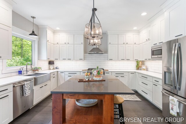 6326 Eaglewood Dr, Hudsonville, MI 49426 - kitchen featuring appliances with stainless steel finishes, a sink, dark wood finished floors, decorative backsplash, and white cabinets
