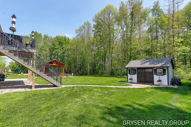6326 Eaglewood Dr, Hudsonville, MI 49426 - view of grassy yard featuring stairs and an outbuilding