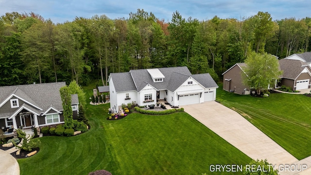 6326 Eaglewood Dr, Hudsonville, MI 49426 - view of front of house with an attached garage, a front yard, driveway, and board and batten siding