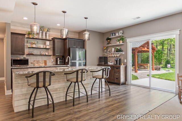 6326 Eaglewood Dr, Hudsonville, MI 49426 - kitchen with open shelves, appliances with stainless steel finishes, dark wood-type flooring, dark brown cabinetry, and recessed lighting