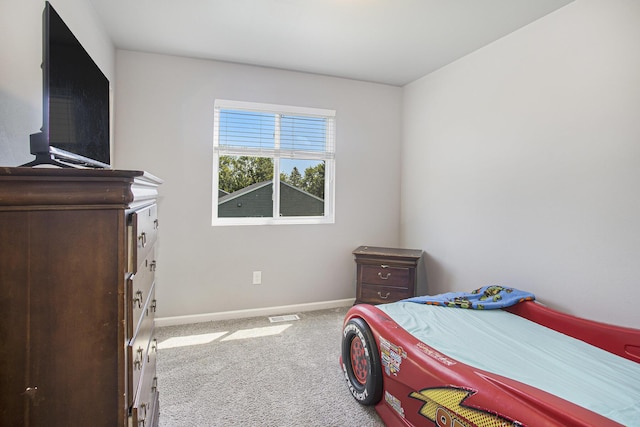 carpeted bedroom featuring baseboards