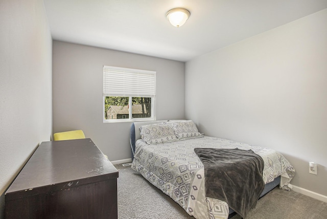carpeted bedroom featuring baseboards