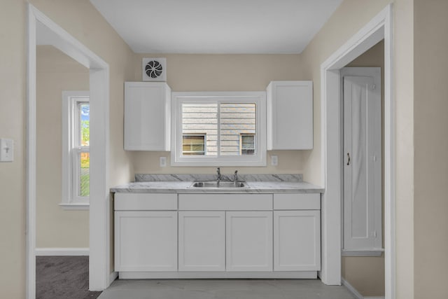 13575 Rutherford St, Detroit, MI 48227 - kitchen with a sink, white cabinetry, and baseboards