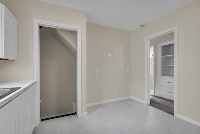 13575 Rutherford St, Detroit, MI 48227 - kitchen featuring white cabinets, light countertops, and baseboards