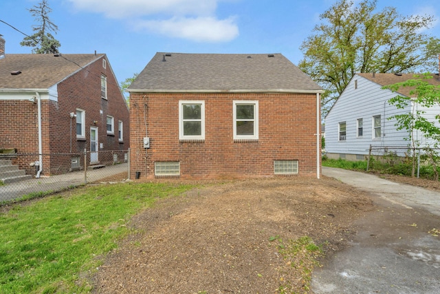 13575 Rutherford St, Detroit, MI 48227 - back of property featuring brick siding, a shingled roof, and fence