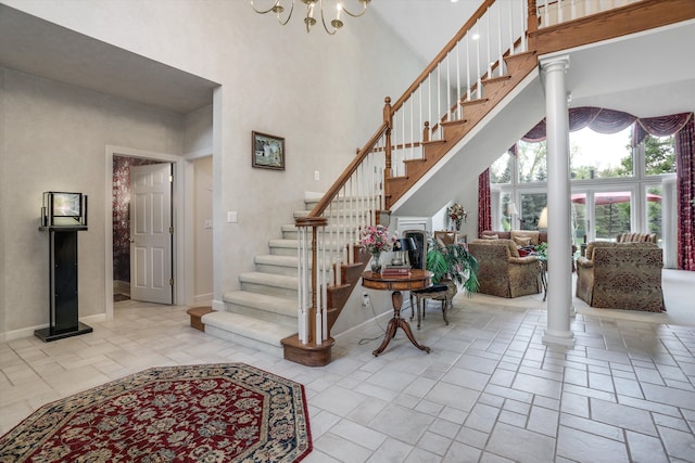 30465 Stonegate Dr, Franklin, MI 48025 - stairway with a high ceiling, baseboards, stone tile flooring, and a chandelier