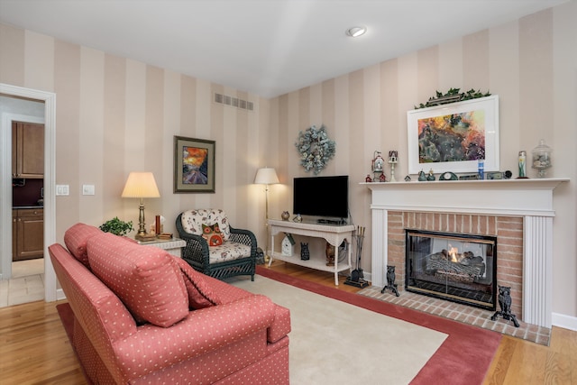 30465 Stonegate Dr, Franklin, MI 48025 - living area featuring wood finished floors, wallpapered walls, a fireplace, and baseboards
