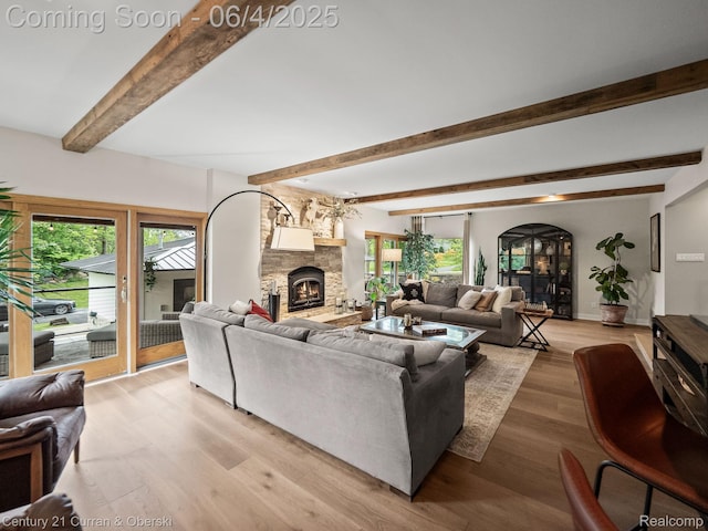 1985 Lone Pine Rd, Bloomfield Hills, MI 48302 - living area with beamed ceiling, light wood-style flooring, and a stone fireplace