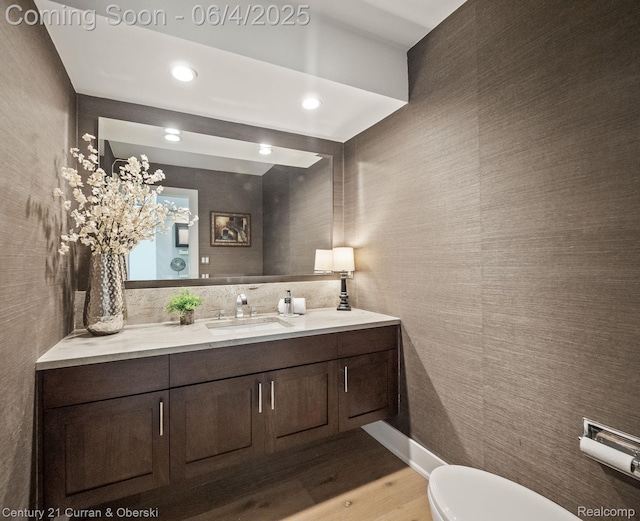 1985 Lone Pine Rd, Bloomfield Hills, MI 48302 - half bath featuring vanity, wood finished floors, toilet, and recessed lighting