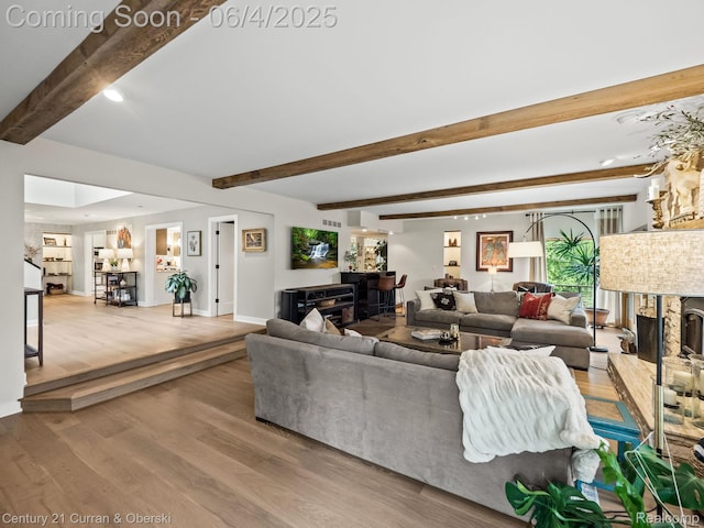 1985 Lone Pine Rd, Bloomfield Hills, MI 48302 - living area with wood finished floors, beam ceiling, baseboards, and a fireplace