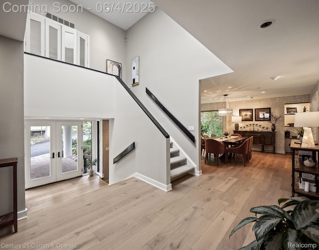 1985 Lone Pine Rd, Bloomfield Hills, MI 48302 - living area with light wood-type flooring, healthy amount of natural light, stairs, a chandelier, and recessed lighting
