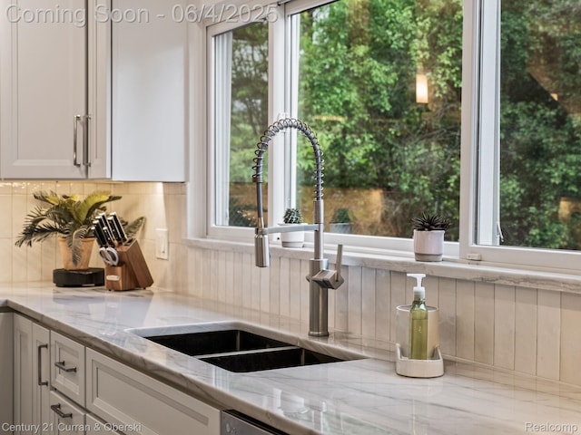 1985 Lone Pine Rd, Bloomfield Hills, MI 48302 - kitchen with a sink, decorative backsplash, light stone countertops, and white cabinetry