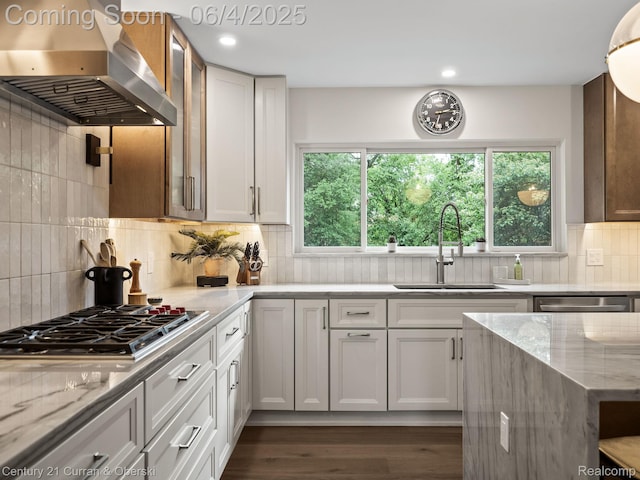1985 Lone Pine Rd, Bloomfield Hills, MI 48302 - kitchen featuring range hood, a sink, light stone counters, appliances with stainless steel finishes, and dark wood-style floors