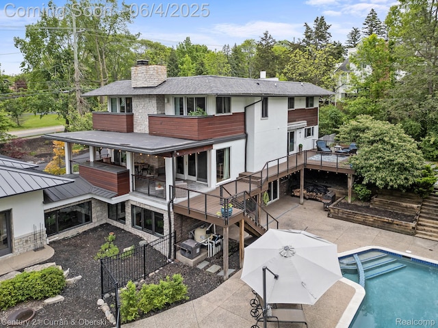 1985 Lone Pine Rd, Bloomfield Hills, MI 48302 - back of house featuring a patio, a fenced backyard, a chimney, stone siding, and a shingled roof