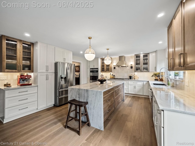 1985 Lone Pine Rd, Bloomfield Hills, MI 48302 - kitchen featuring appliances with stainless steel finishes, wall chimney range hood, tasteful backsplash, a sink, and recessed lighting
