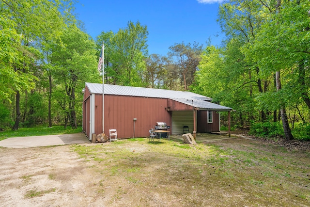 7642 Jordan Rd, Yale, MI 48097 - back of property featuring an outbuilding, a garage, and metal roof