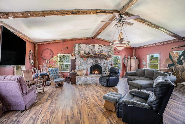 living area with wood finished floors, ceiling fan, and a fireplace