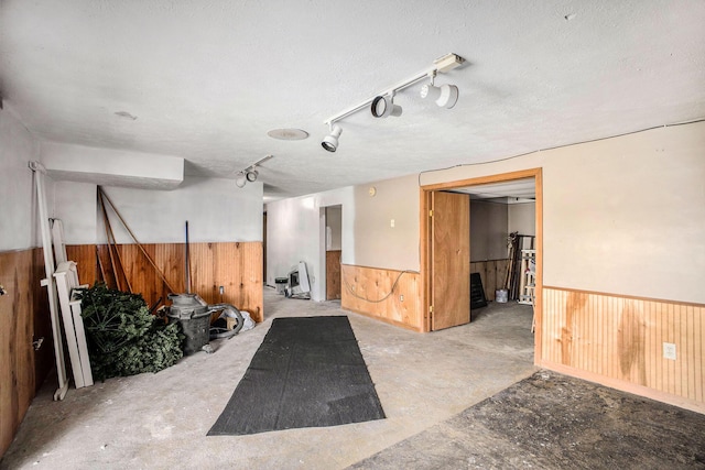 garage featuring wooden walls and wainscoting