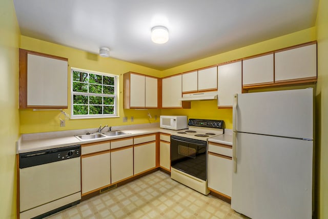 225 Brookwood Dr Unit 4, South Lyon, MI 48178 - kitchen featuring white appliances, under cabinet range hood, a sink, light countertops, and light floors