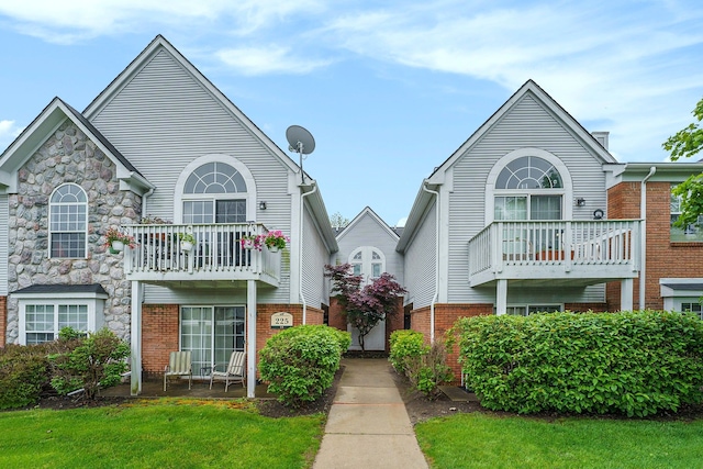 225 Brookwood Dr Unit 4, South Lyon, MI 48178 - view of front of property featuring a balcony and brick siding