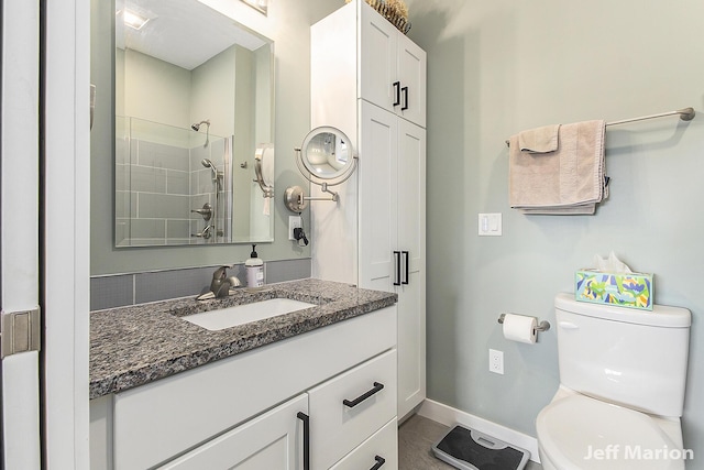1525 W David Hwy, Ionia, MI 48846 - full bathroom with toilet, baseboards, vanity, and a tile shower