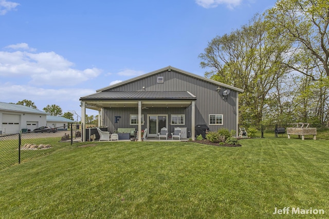 1525 W David Hwy, Ionia, MI 48846 - back of house with outdoor lounge area, ceiling fan, a patio area, and a detached garage