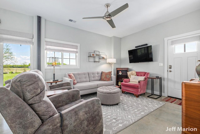 1525 W David Hwy, Ionia, MI 48846 - living room featuring plenty of natural light, finished concrete floors, and ceiling fan