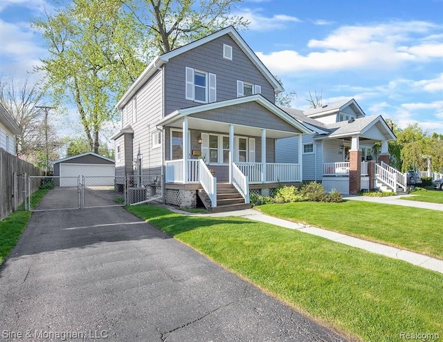 view of front of home with a porch, a garage, a gate, and an outdoor structure