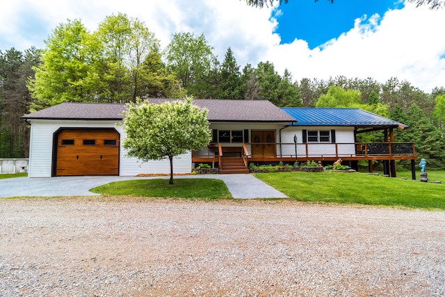 4707 Mount Morris Rd, Columbiaville, MI 48421 - view of front of property featuring gravel driveway, an attached garage, a front yard, and a porch