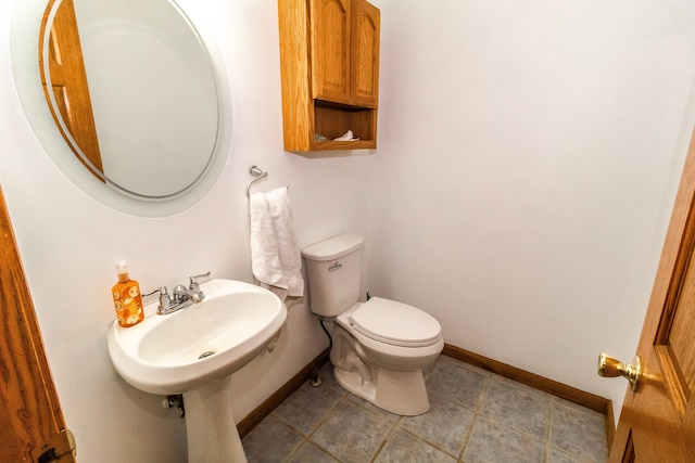 4707 Mount Morris Rd, Columbiaville, MI 48421 - half bath featuring baseboards, toilet, tile patterned flooring, and a sink
