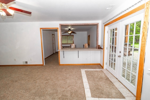 4707 Mount Morris Rd, Columbiaville, MI 48421 - unfurnished living room featuring french doors, a ceiling fan, baseboards, and light carpet
