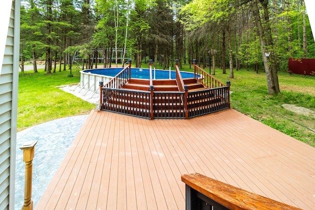 4707 Mount Morris Rd, Columbiaville, MI 48421 - wooden deck featuring a yard and an outdoor pool
