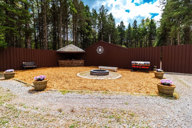 4707 Mount Morris Rd, Columbiaville, MI 48421 - view of yard featuring an outdoor fire pit and fence
