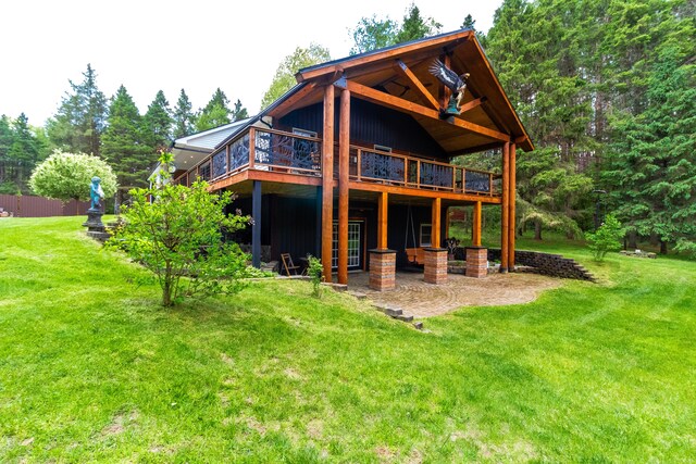 4707 Mount Morris Rd, Columbiaville, MI 48421 - back of property with a lawn, a wooden deck, and a patio area